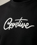 Bluză bărbătească neagră casual cu mânecă lungă și imprimeu text 'creative', ideală pentru ținute urbane și streetwear