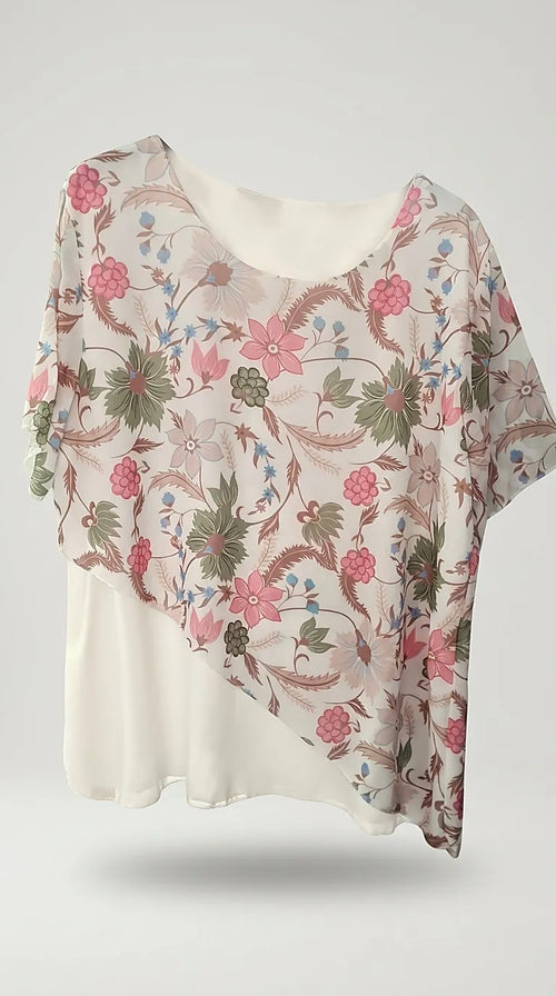 Bluză de damă albă cu imprimeu floral multicolor în nuanțe de roz și verde, mânecă scurtă și design asimetric suprapus