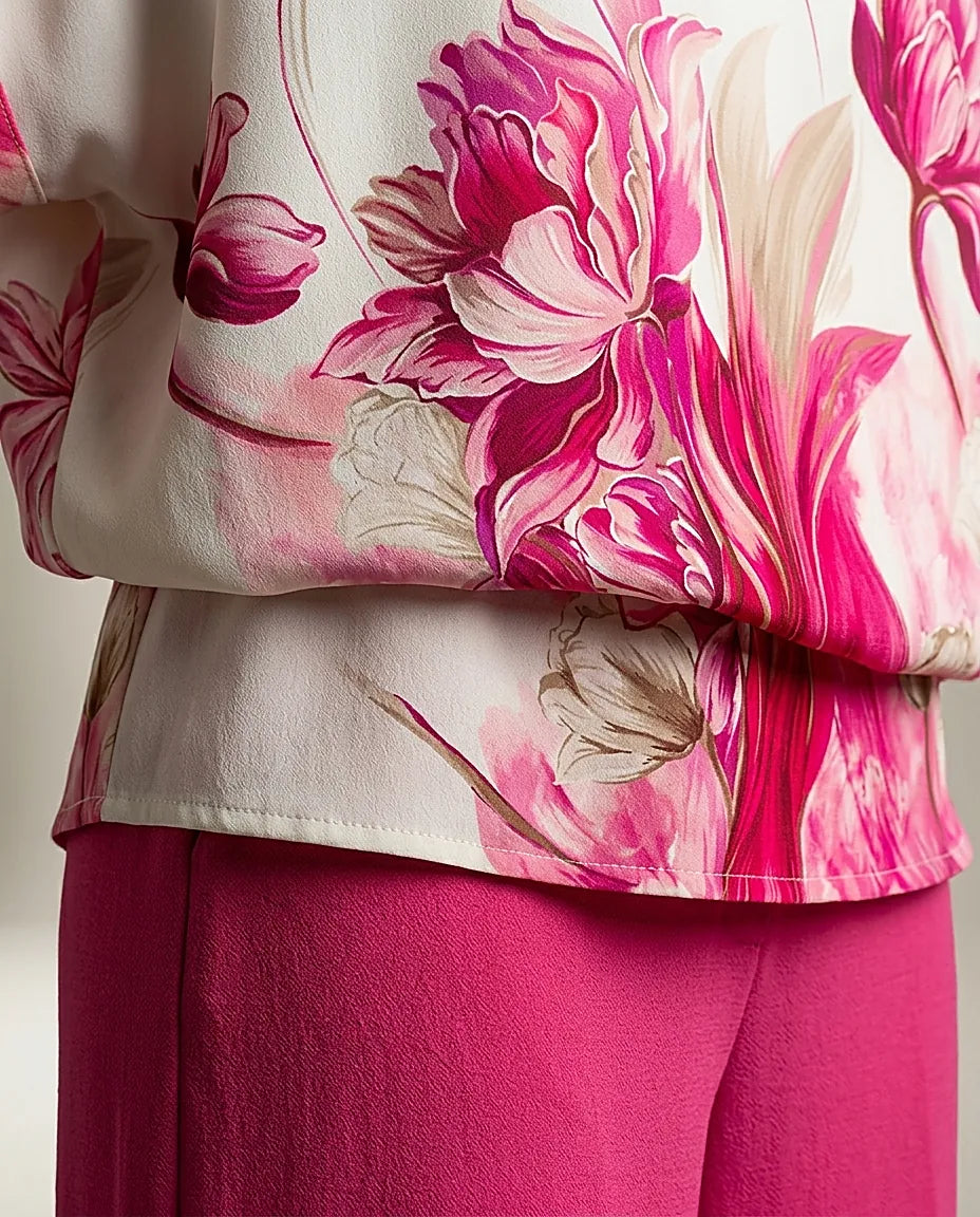 Compleu elegant de damă din două piese, cu bluză albă vaporoasă cu imprimeu floral roz și pantaloni evazați fucsia