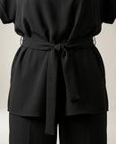 Compleu elegant negru de damă din două piese, cu top lejer cu cordon în talie și pantaloni largi, ținută versatilă casual-chic
