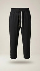 Pantaloni jogger negri de damă cu talie elastică și șnur alb, model casual relaxed fit, perfecți pentru ținute lejere de zi