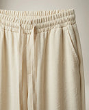 Pantaloni lungi de damă crem cu talie elastică și șnur, model casual-elegant din material fluid